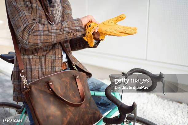 close-up of an unrecognizable man putting on his leather gloves - leather glove stock pictures, royalty-free photos & images