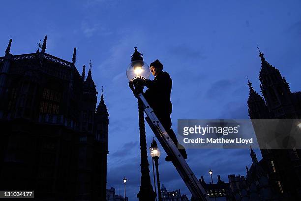 British Gas engineer Martin Caulfield services and cleans a gas lamp in Westminster on October 31, 2011 in London, England. Caulfield has been...