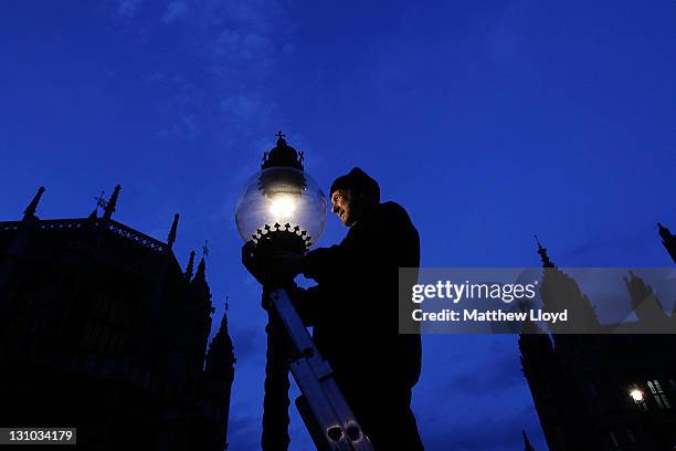 British Gas engineer Martin Caulfield services and cleans a gas lamp in Westminster on October 31, 2011 in London, England. Caulfield has been...