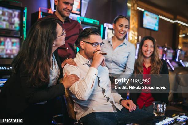 friends gambling on slot machines - jackpot stock pictures, royalty-free photos & images