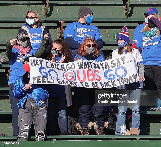 Fans in the center field bleachers hold a sign during the Opening Day home game between the Chicago Cubs and the Pittsburgh Pirates at Wrigley Field...