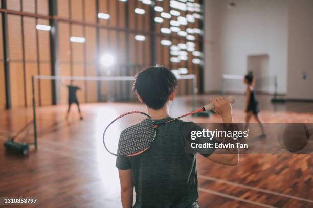 asian chinese female badminton coach trainer waiting and watching team mate playing practicing  in badminton cour - badminton stock pictures, royalty-free photos & images