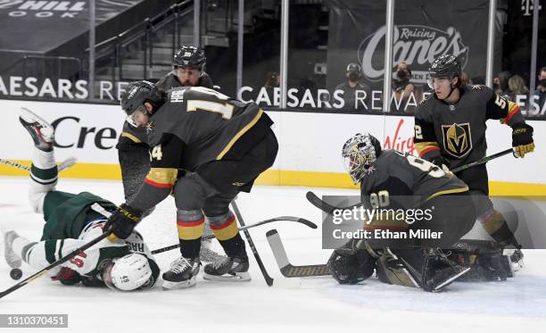 Victor Rask of the Minnesota Wild falls to the ice after Robin Lehner of the Vegas Golden Knights blocked his shot as Nicolas Hague, Alex Tuch and...