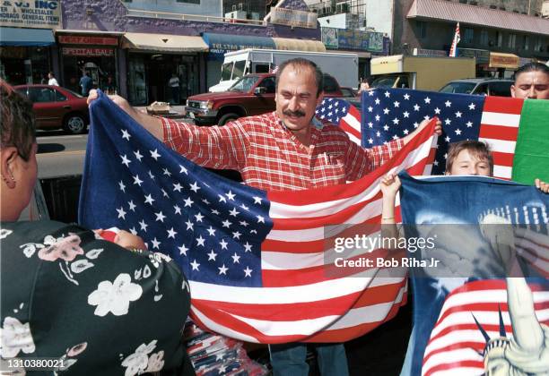 Flag vendor Manuel Ramirez sells American flag bath towels along Los Angeles Street, September 15, 2001 in Los Angeles, California.