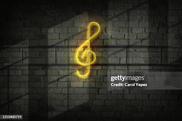 treble clef of neon glowing intermittent line on black background. abstract luminous background. photographic effect of long exposure. close-up, copy space. - bar wall stock pictures, royalty-free photos & images