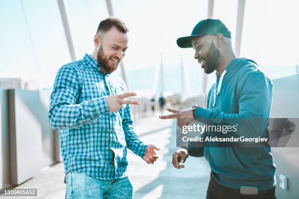 rock, paper, scissors between caucasian and african male friends outside - rock paper scissors stock pictures, royalty-free photos & images