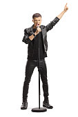 Full length portrait of a male teenage singer with a microphone