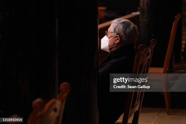 Man wearing a FFP2 face mask attends a Good Friday religious service during Easter at the Protestant Berlin Cathedral during the third wave of the...