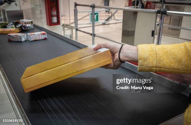 a person putting products on the supermarket checkout tape. - checkout conveyor belt stock pictures, royalty-free photos & images