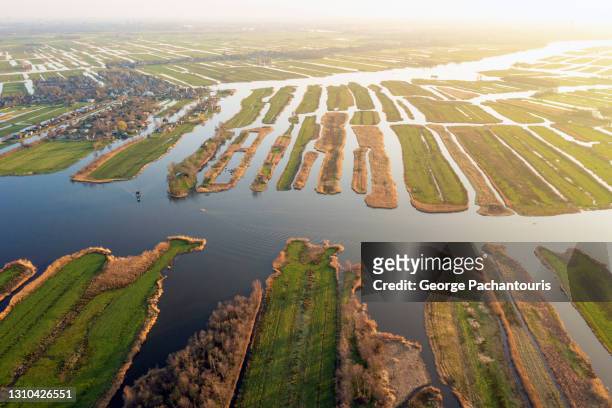 aerial photo of marshland, grassland and open water in holland - peat stock pictures, royalty-free photos & images