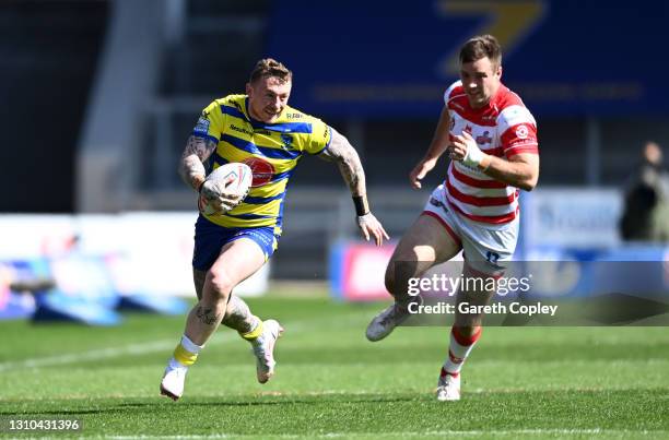 Josh Charnley of Warrington gets past Iain Thornley of Leigh during the Betfred Super League match between Warrington Wolves and Leigh Centurions at...