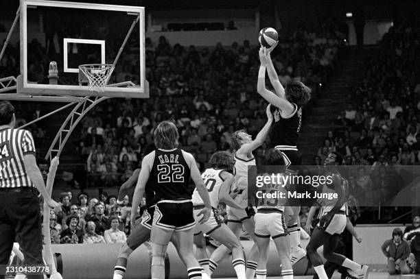 Billy Paultz of the San Antonio Spurs shoots a jumper over Dan Issel during an ABA game against the Denver Nuggets at McNichols Arena on January 23,...