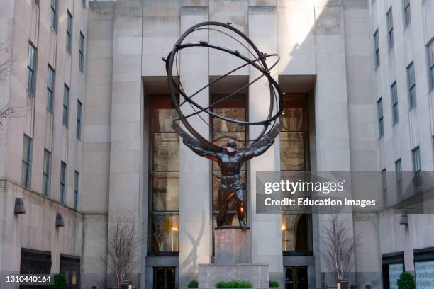 Statue of Atlas wearing face mask, Rockefeller Center, Manhattan, New York.