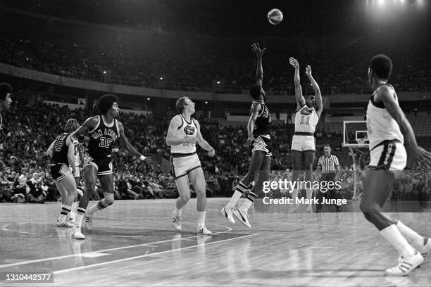 January 23, 1976: Denver Nuggets guard Chuck Williams shoots a jumper over Mike Gale during an ABA game against the San Antonio Spurs at McNichols...