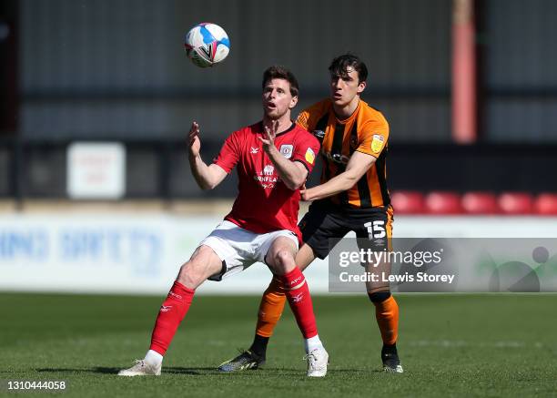 Chris Porter of Crewe Alexandra battles for possession with Alfie Jones of Hull City during the Sky Bet League One match between Crewe Alexandra and...