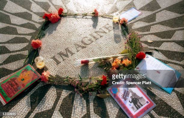 Roses and cards sit lay on the ''Imagine'' circle mosaic December 7, 2000 in the area known as ''Strawberry Fields'' in New York City''s Central Park...