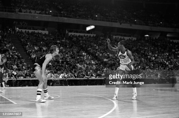 Guard Jimmy Foster of the Denver Nuggets signals a play while guarded by George Karl during an ABA game against the San Antonio Spurs at McNichols...