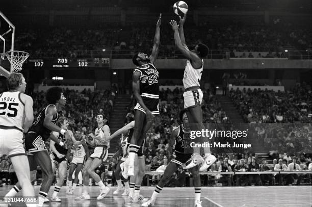 David Thompson of the Denver Nuggets shoots a jumper over Ken Smith during an ABA game against the San Antonio Spurs at McNichols Arena on January...