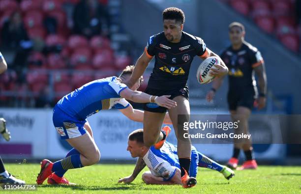 Derrel Olpherts of Castleford gets past Jack Broadbent of Leeds during the Betfred Super League match between Leeds Rhinos and Castleford Tigers at...