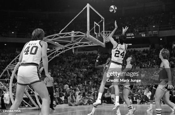 Denver Nuggets forward Bobby Jones shoots a jump shot over Larry Kenon and Mark Olberding as George Karl watches during an ABA game against the San...