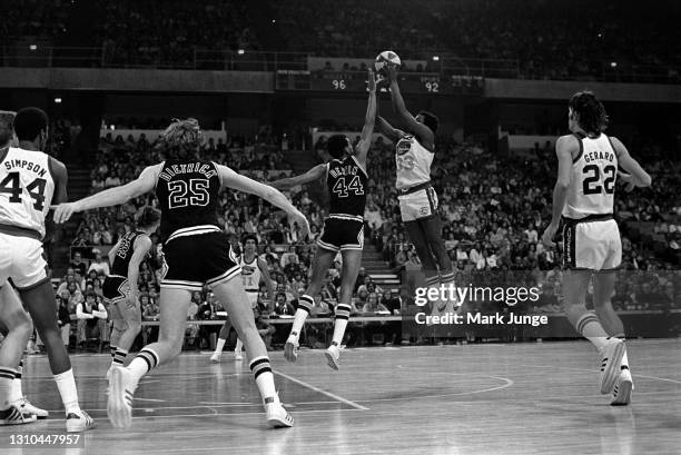 Denver Nuggets forward David Thompson shoots a jump shot over George Gervin during an ABA game against the San Antonio Spurs at McNichols Arena on...