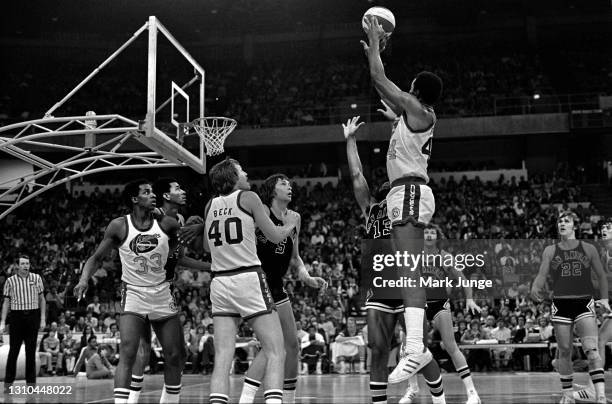 Denver Nuggets guard Ralph Simpson shoots a jump shot over James Silas during an ABA game against the San Antonio Spurs at McNichols Arena on January...