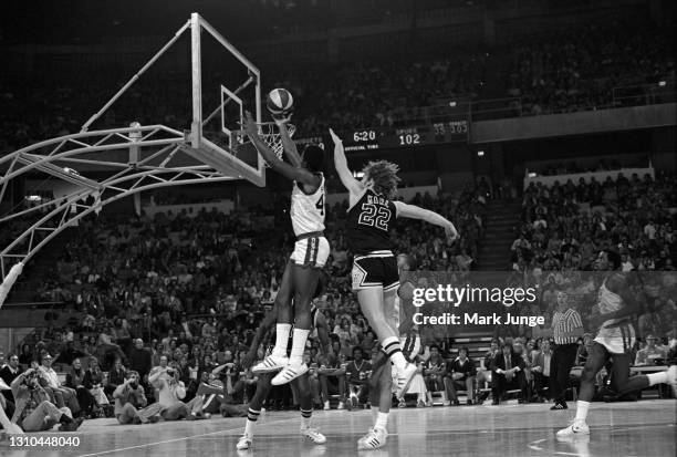 San Antonio Spurs guard George Karl attempts to block a layup by Ralph Simpson while Jimmy Foster, and David Thompson trail the play during an ABA...