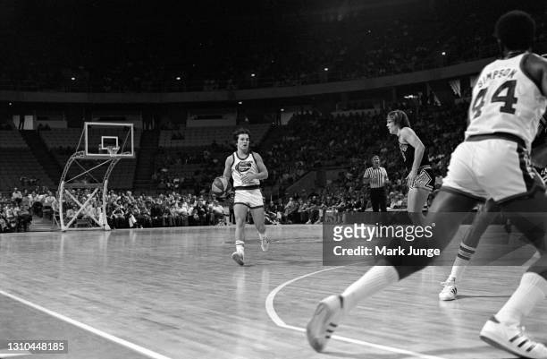 Denver Nuggets guard Monte Towe contemplates a pass to Ralph Simpson while guarded by George Karl during an ABA game against the San Antonio Spurs at...