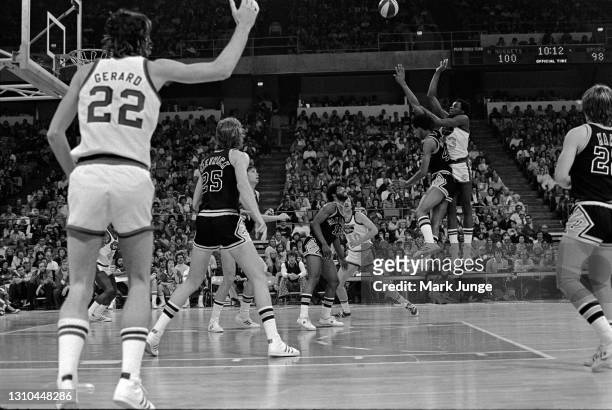 Denver Nuggets forward David Thompson shoots a jumper over George Gervin during an ABA game against the San Antonio Spurs at McNichols Arena on...