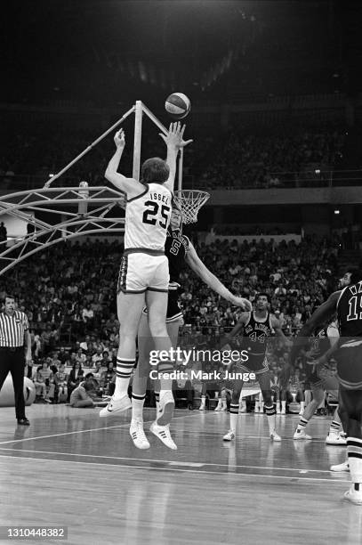 Denver Nuggets center Dan Issel shoots a jump shot over Billy Paultz during an ABA game against the San Antonio Spurs at McNichols Arena on January...