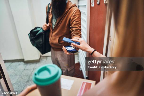 food delivery person, scanning the customer qr code on mobile phone, for a payment transaction after he deliver the food order on her door - take away food courier stock pictures, royalty-free photos & images