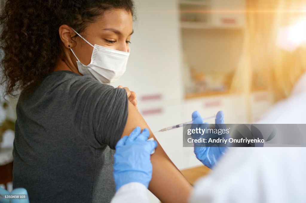 Young woman getting vaccinated