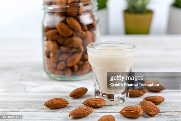 almonds in a jar, a glass of almond milk - almond milk stock pictures, royalty-free photos & images