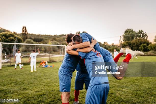 soccer players  celebrating a goal - the championship soccer league stock pictures, royalty-free photos & images