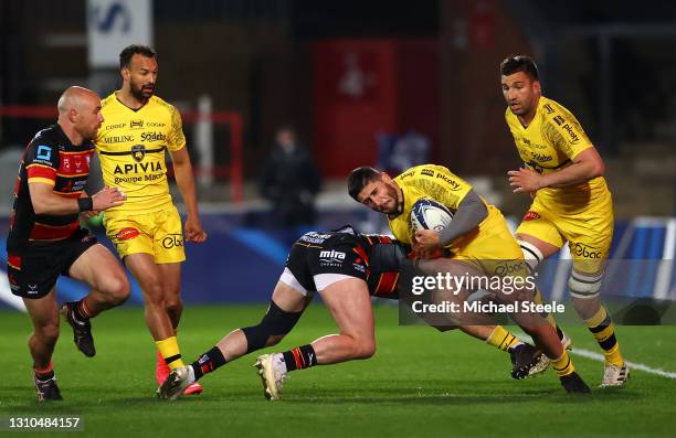 Arthur Retiere of La Rochelle is tackled by Charlie Sharples of Gloucester during the Heineken Champions Cup Round of 16 match between Gloucester...