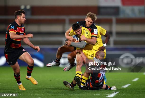 Arthur Retiere of La Rochelle is tackled by Charlie Sharples and Chris Harris of Gloucester during the Heineken Champions Cup Round of 16 match...