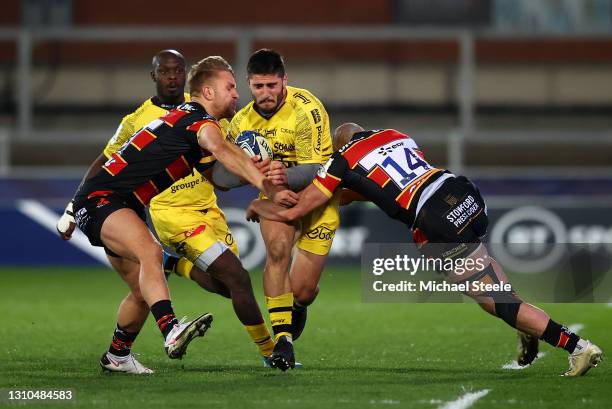 Arthur Retiere of La Rochelle goes in to contact with Charlie Sharples and Chris Harris of Gloucester during the Heineken Champions Cup Round of 16...