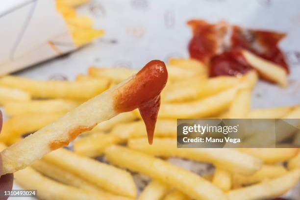 a person eating french fries with ketchup. - schets stock pictures, royalty-free photos & images