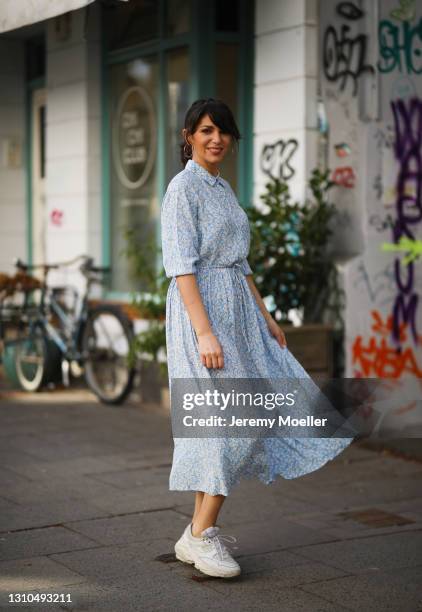 Anna Wolfers poses wearing light blue floral dress and white sneakers on March 30, 2021 in Hamburg, Germany.