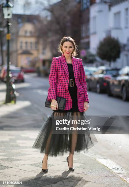 Alexandra Lapp is seen wearing BALENCIAGA checked Hourglass blazer in pink and black, ALEXANDER MCQUEEN off-shoulder knitted top in black, ALEXANDER...