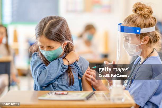 school child getting a vaccine - preschool-teacher-mask stock pictures, royalty-free photos & images