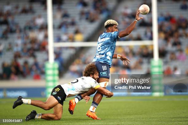 Hoskins Sotutu of the Blues is tackled by Orbyn Leger of the Hurricanes during the round 6 Super Rugby Aotearoa match between the Blues and the...