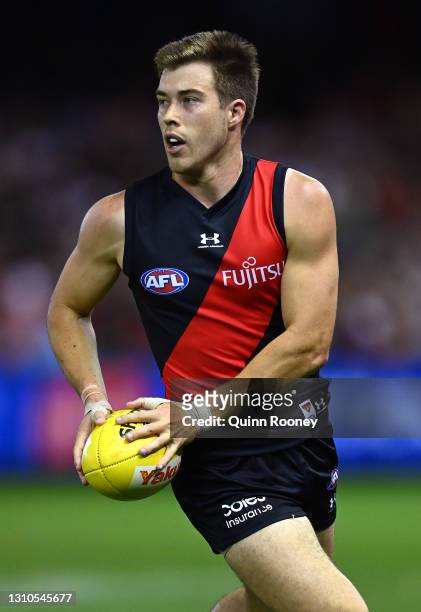 Zach Merrett of the Bombers looks to pass the ball during the round 3 AFL match between the Essendon Bombers and the St Kilda Saints at Marvel...