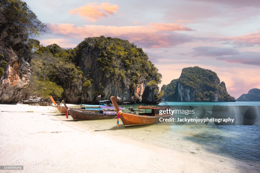 Long tail boat on koh lao la ding beach in Krabi during a sunny day , Thailand , Asia