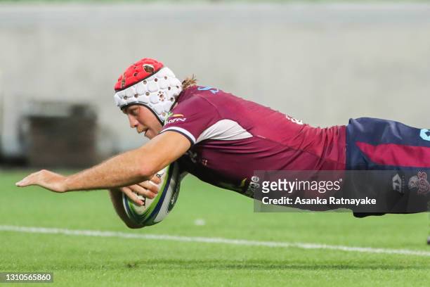 Fraser McReight of the Reds dives to score a try during the Super RugbyAU, round 7 match between the Melbourne Rebels and the Queensland Reds at AAMI...