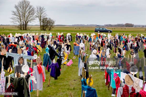 Dolls are seen lined up in a grassland on April 2, 2021 in Morra, Netherlands. 4.222 dolls have been lined up in the Frisian village of Morra to ask...