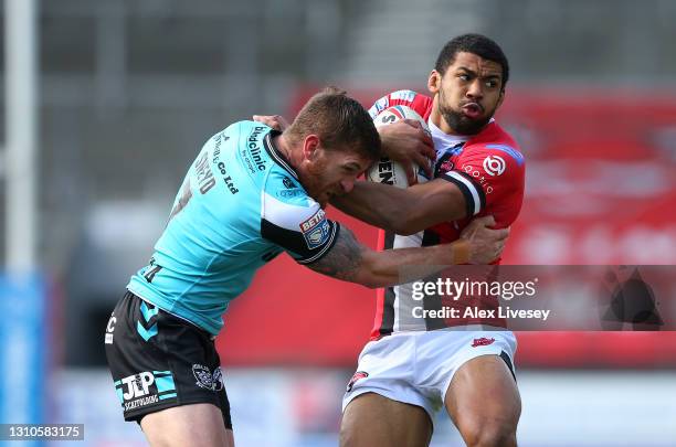 Kallum Watkins of Salford Red Devils is tackled by Marc Sneyd of Hull FC during the Betfred Super League match between Salford Red Devils and Hull FC...