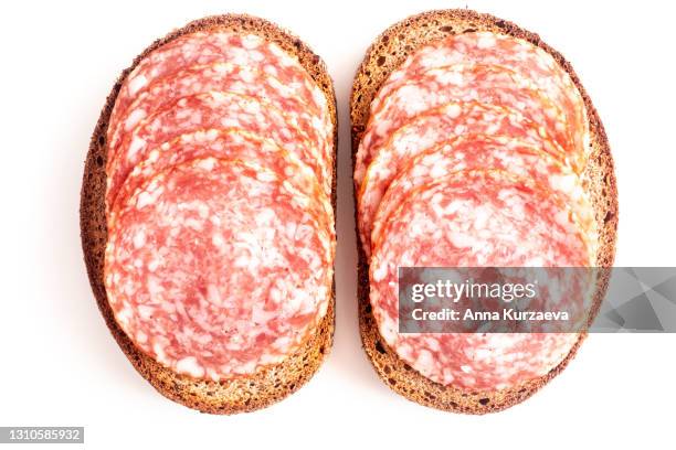 sliced salami on rye bread isolated on white background - rye bread stock pictures, royalty-free photos & images