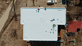 Aerial view of an apartment building with flat roof in construction, ballasted system with geotextile, PVC or EPDM membrane