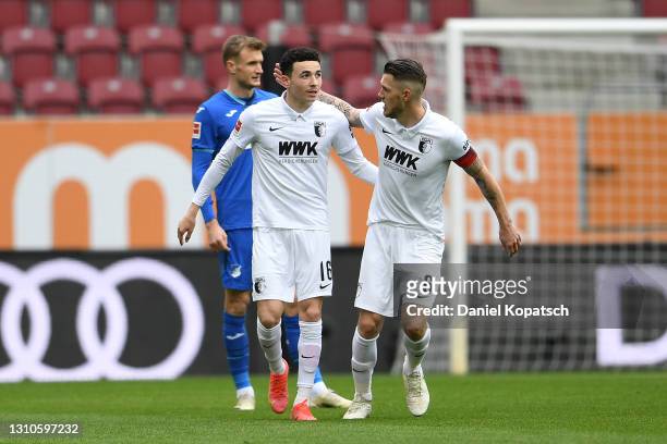 Ruben Vargas of FC Augsburg celebrates with team mate Jeffrey Gouweleeuw after scoring their side's first goal during the Bundesliga match between FC...